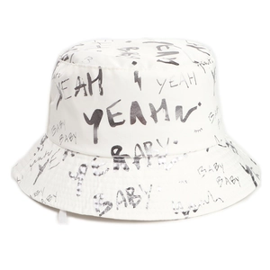 Detail of white canvas bucket hat featuring black graffiti lettering and baby doodle prints