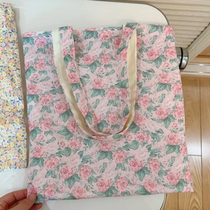 Detail of pink floral print canvas tote bag with large capacity and soft cotton handles
