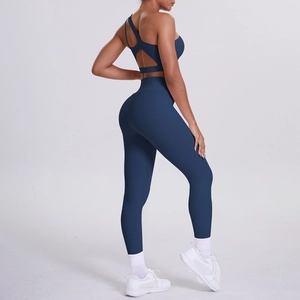 Detail of navy blue one-shoulder yoga set showing open back cutout and high waist fit