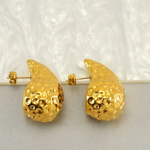 Detail of 18K gold stainless steel teardrop earrings with hammered texture and bright finish