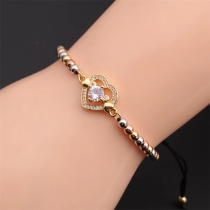 Detail of adjustable heart bracelet with tricolor beads and shimmering cubic zirconia