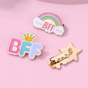 Macro detail of BFF rainbow enamel pins showing front designs and metal safety pin back