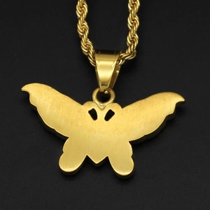 Hip hop style gold stainless steel butterfly pendant necklace on a sleek black background