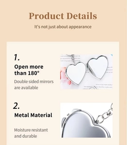 Detail of silver heart-shaped compact mirror with 180-degree opening and metal clasp