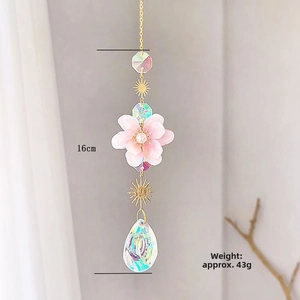 Detail view of pink crystal cherry blossom suncatcher with rainbow teardrop pendant