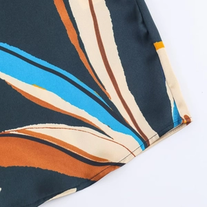 Detailed view of dark green floral print shirt with high-quality hem stitching