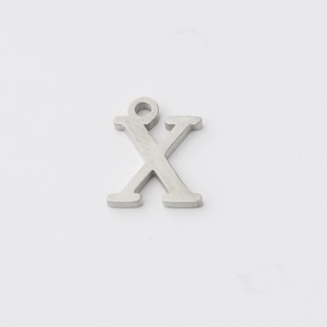 Macro shot of silver stainless steel letter X pendant with a polished mirror finish