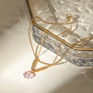 Close-up of 16k gold stainless steel anklet featuring a pink crystal butterfly pendant