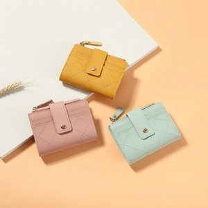 Close-up of pastel PU leather wallets with quilted texture and gold zipper detail