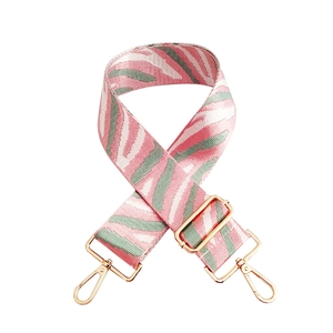 Adjustable woven bag strap with pink and mint green wave patterns and gold hardware