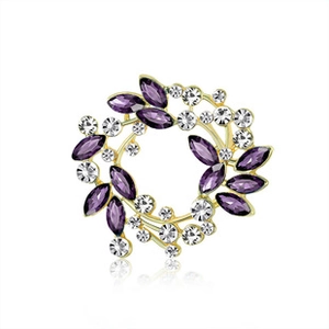 Detailed macro shot of vintage peacock feather brooch with purple rhinestones and gold base