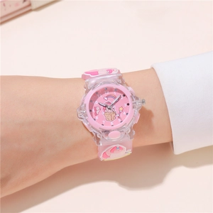 Close-up of pink unicorn children watch worn on wrist with luminous dial and silicone strap