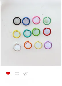 Macro view of colorful lacquered metal open jump rings in 12 assorted vibrant colors