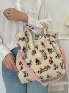 Fleece tote bag with floral print, adjustable pink strap and brown brand label