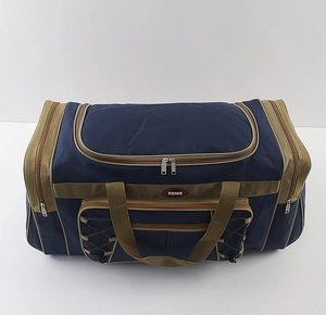 Detail view of large navy blue travel bag with multi-zipper pockets and reinforced handles