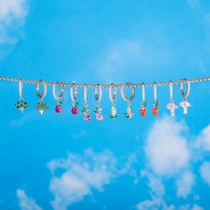 Detail of vibrant 18K gold plated vegetable earrings with colorful micro-set gemstones
