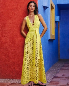 Detailed close-up of yellow laser-cut floral pattern on a deep V-neck beach maxi dress