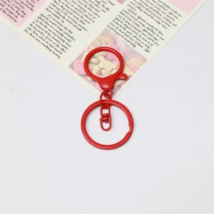 Detail view of red painted metal lobster clasp with key ring for DIY jewelry making