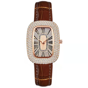 Close-up of rose gold lady watch with rhinestone bezel and brown alligator leather strap