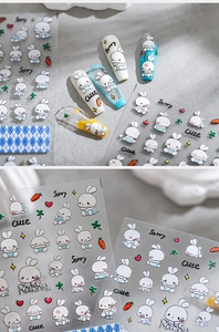 Detail view of 3D embossed nail stickers featuring cute white rabbits and hearts