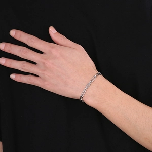 Close-up of a silver stainless steel paperclip link bracelet worn on a wrist