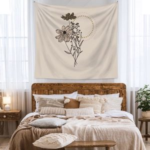 Detail of bohemian wall tapestry featuring minimalist floral line art and gold circle