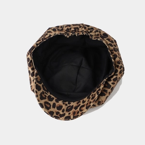 Leopard print newsboy cap with black inner lining shown from a top-down interior perspective