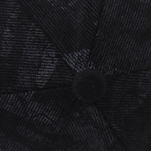 Close-up of the top button and stitched seams on a textured graffiti baseball cap