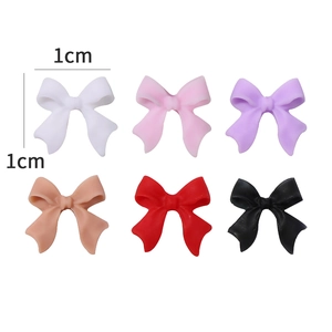 Detailed view of 1cm 3D matte bow nail charms in six vibrant assorted colors