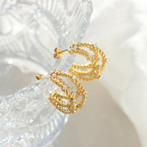 Elegant gold C-shaped hoop earrings with twisted rope texture and cubic zirconia studs