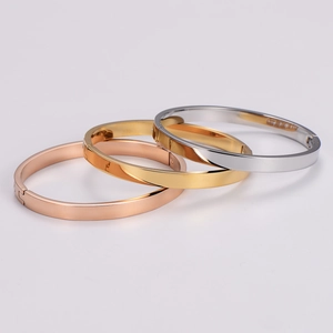 Minimalist stainless steel oval bangles in rose gold, gold, and silver finishes