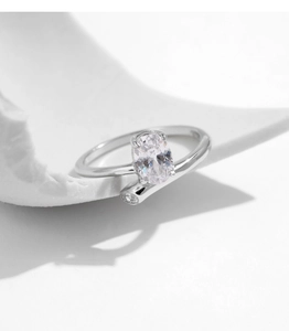 Macro detail of s925 silver oval cubic zirconia ring with minimalist crossover band design