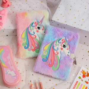 Close-up of plush unicorn A5 notebooks with rainbow faux fur and embroidery details