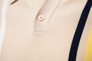 Close-up of knit polo collar with contrast stripes and fine textured needlework details