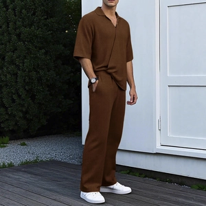 Men's dark brown short sleeve knit polo and pants set with ribbed texture in outdoor setting