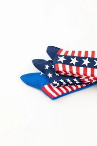 Detail of stacked cotton socks featuring stars and stripes American flag pattern in blue, white, red