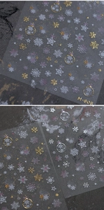Macro shot of M-808 Christmas nail art stickers with golden snowflakes and ornaments
