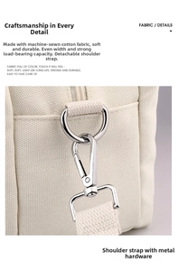 Detail showing durable silver metal hardware and detachable strap on ivory canvas bag