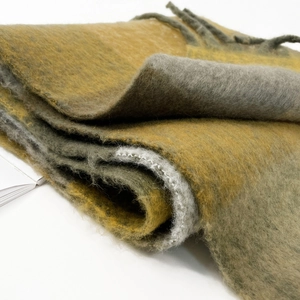 Close-up of thick mustard yellow and dark green mohair scarf with soft brushed texture