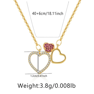 Detail view of gold-plated stacked hearts necklace with pink and white crystal accents