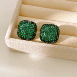 Macro shot of square emerald green pave-set earrings in vintage gunmetal finish