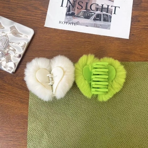 Cute heart-shaped faux fur hair claw clips in white and neon green for winter styling