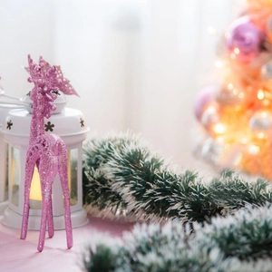 Christmas decoration set with pink glitter reindeer, white lantern and green garland