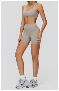 Side view of taupe yoga set featuring a U-neck sports bra and high-waisted seamless shorts