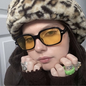 Retro square sunglasses with thick black frames and vibrant yellow lenses