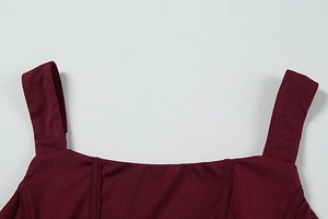 Detail of square neckline on burgundy slim dress with double-stitched shoulder straps