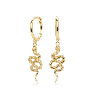 Detail view of gold snake earrings with intricate scale texture on a reflective surface