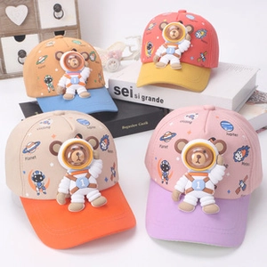 Detail of colorful kids astronaut caps with 3D bear ornaments and space prints
