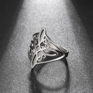 Macro shot of silver vintage hollowed-out Celtic knot pattern on stainless steel ring