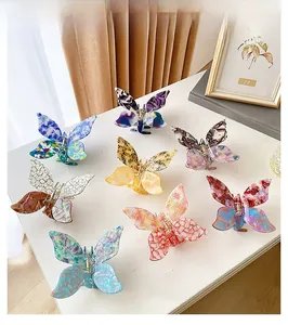 Detailed grid of eight butterfly hair claws in acetate with various marbled finishes